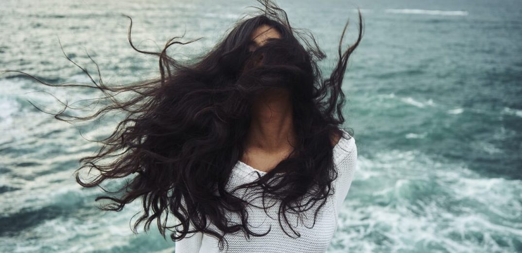 woman in a beach with black hair